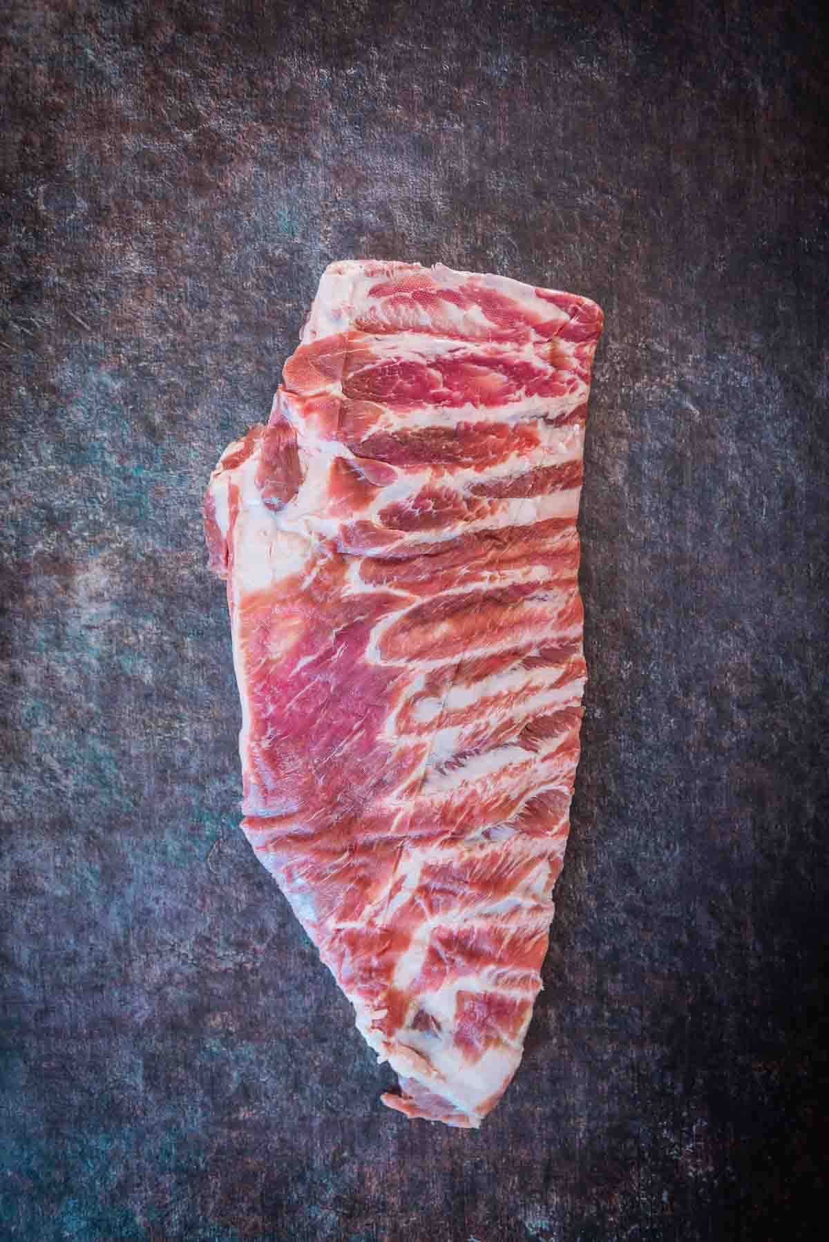 Slab of spare ribs on a counter.