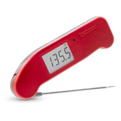 A red digital thermometer on a white background.