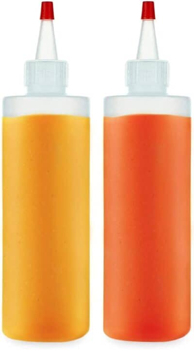 Two orange and yellow bottles with lids on a white background.
