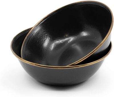 Two black bowls with gold rims on a white background.