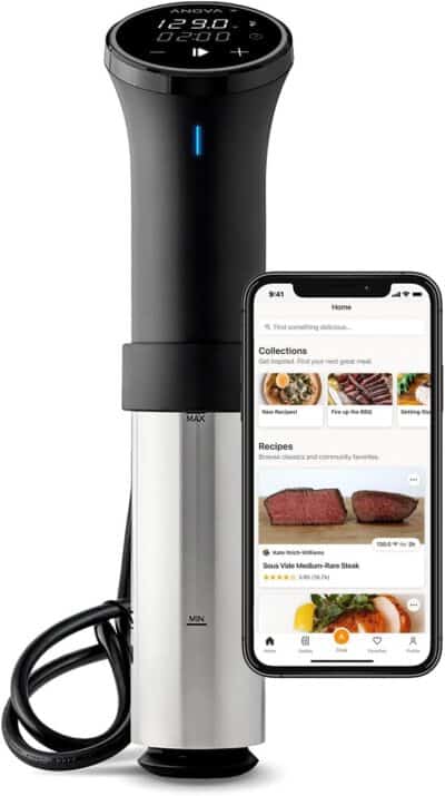 A food processor with a smartphone next to it.