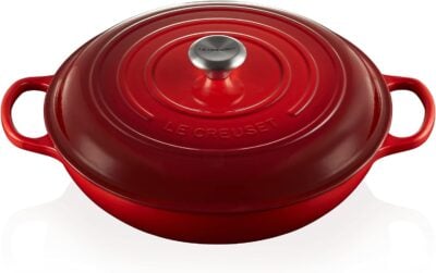 A red le creuset oven on a white background.