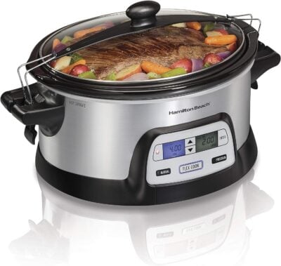 A hamilton beach slow cooker with vegetables and meat.