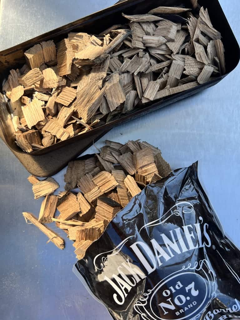 Bag of Jack Daniels wood chips with chips in a smoker box. 