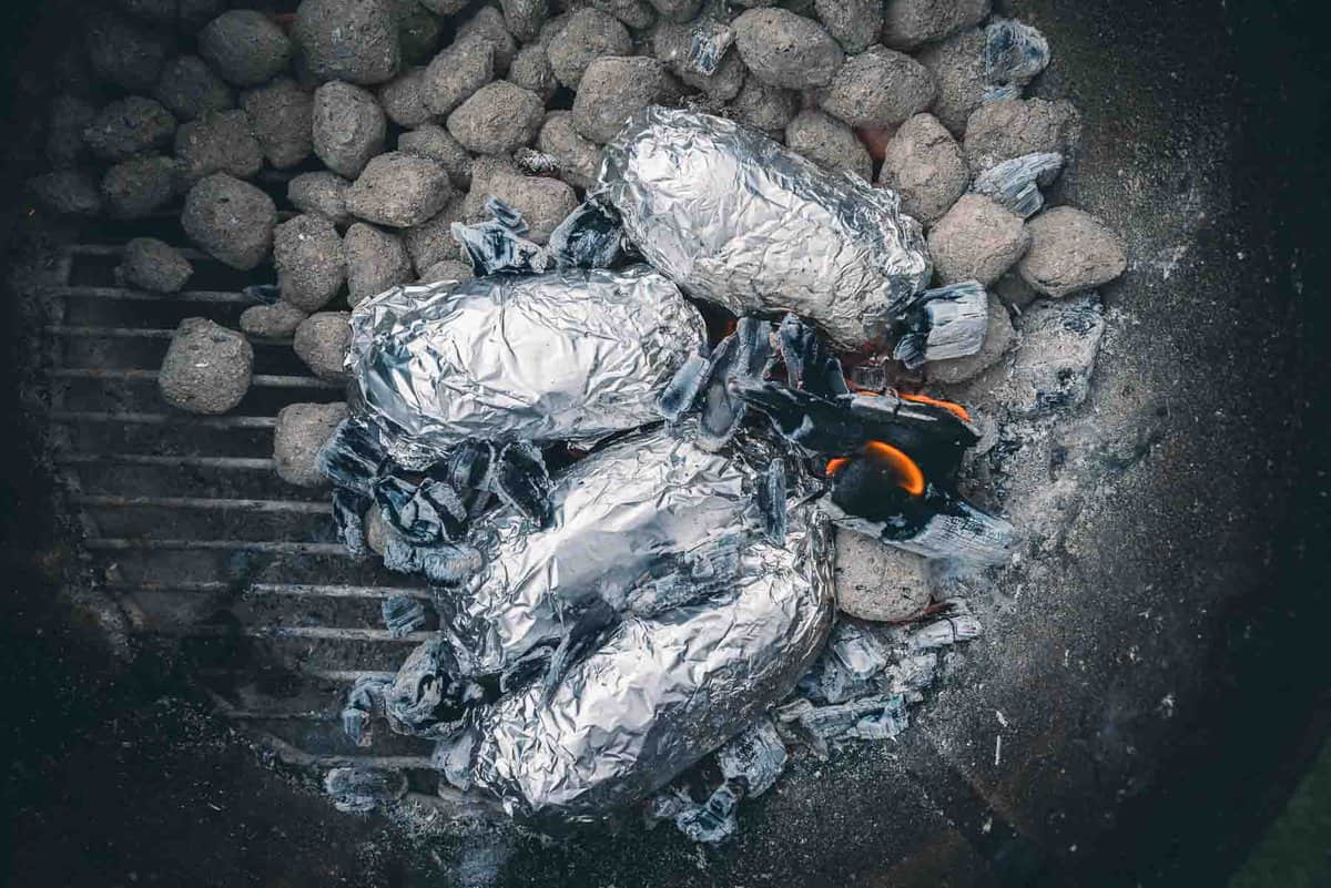 Foil wrapped and cooking in the embers. 