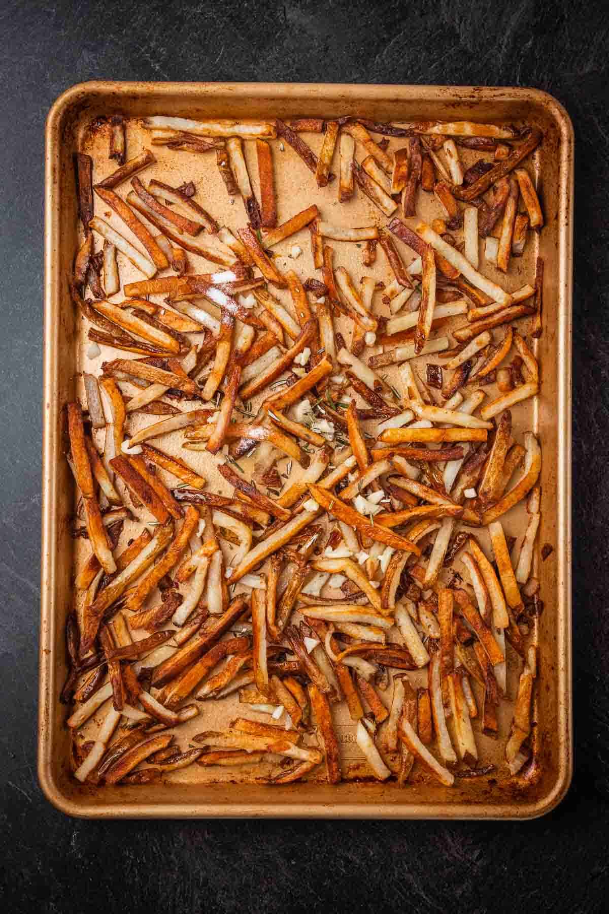 Bakng sheet with fries prepped for cooking.