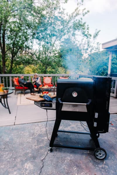 A bbq grill with smoke coming out of it.
