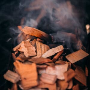 Smoking wood chips on a grill.