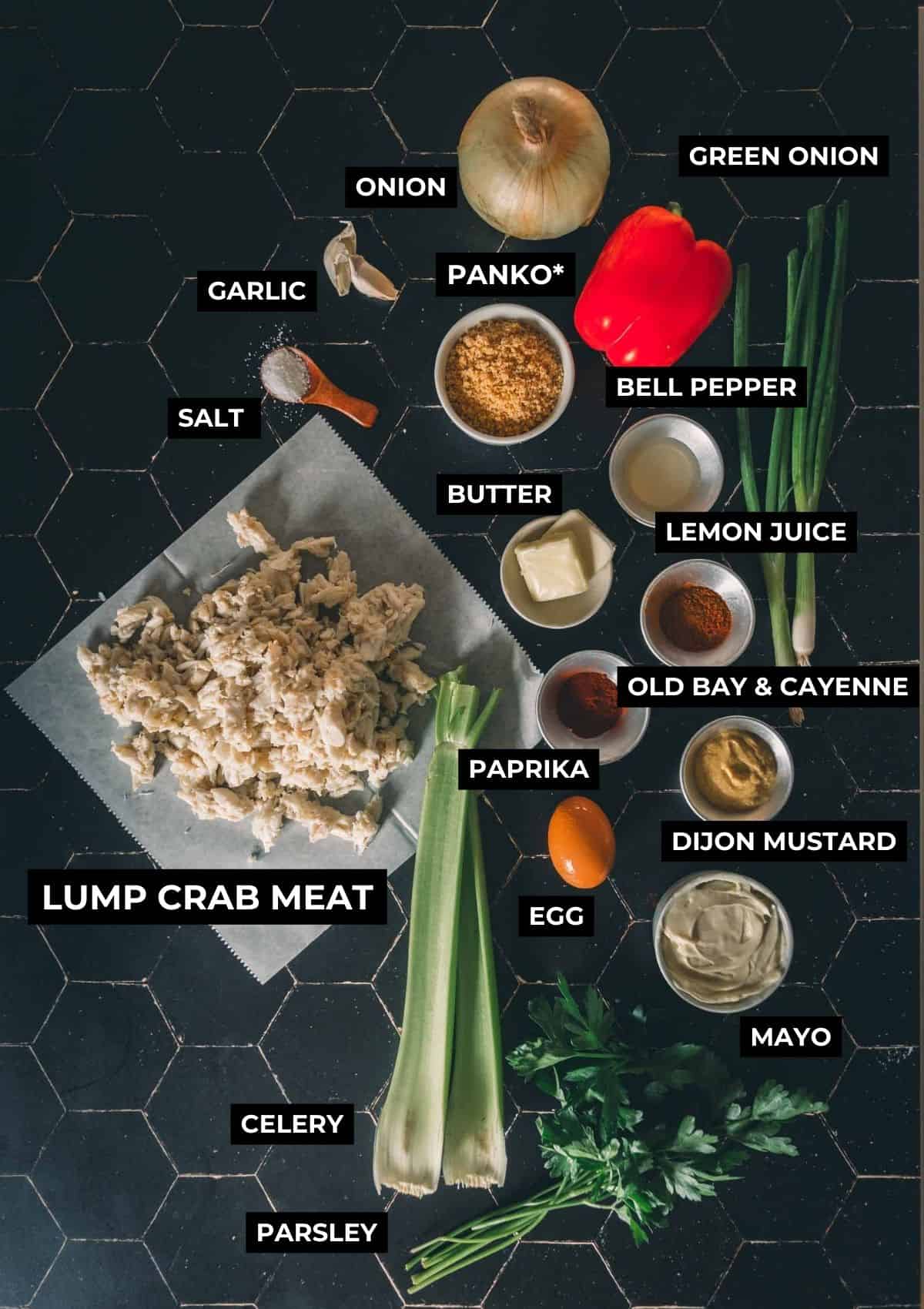 Ingredients for this crab recipe arranged on a black table.