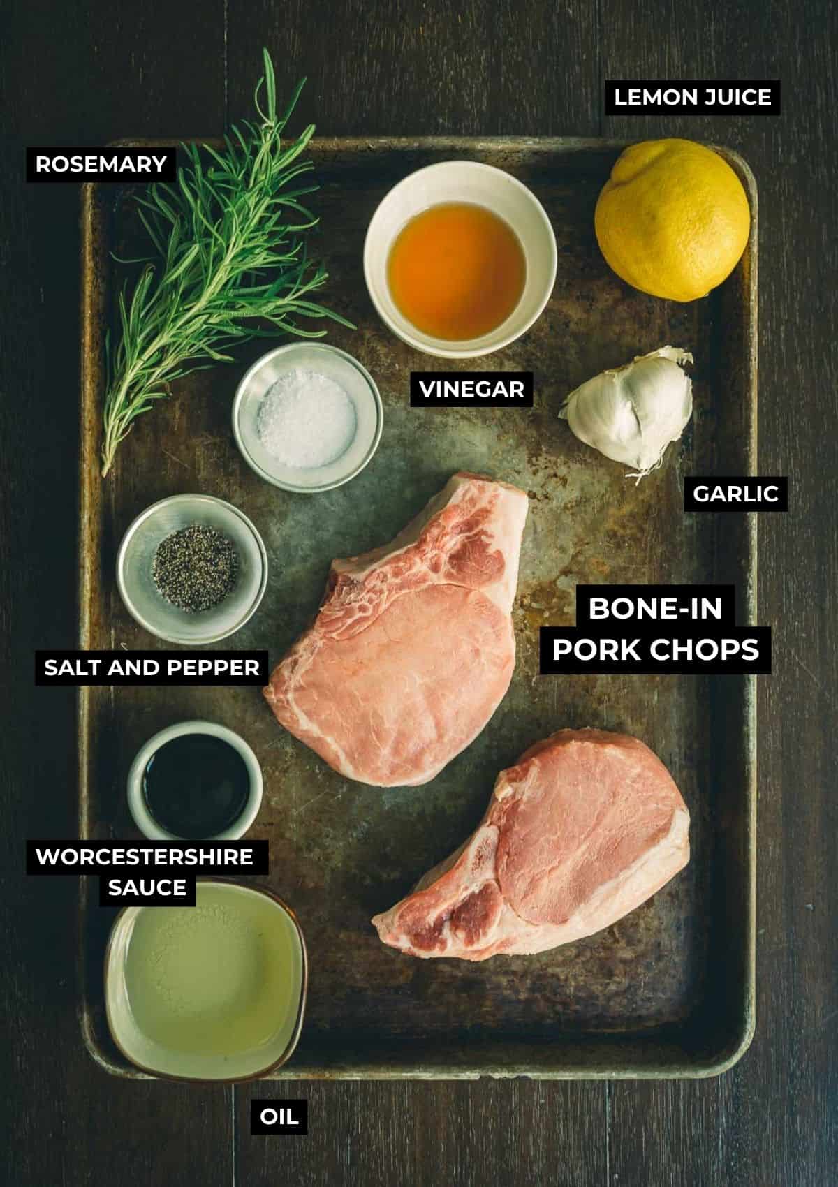 Ingredients for grilled pork chops with marinade on a table.