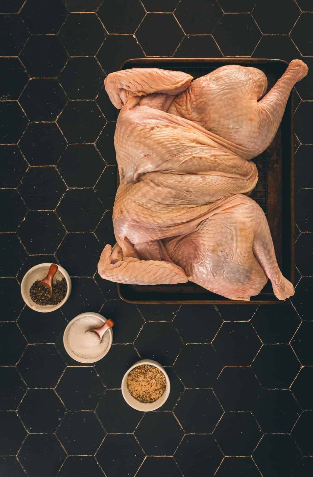 Ingredients for dry brine on a board with turkey. 