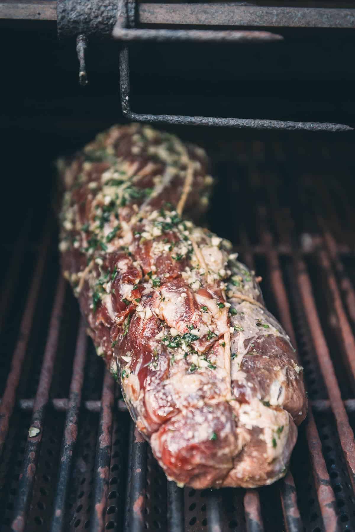 The whole beef tenderloin roast on the grill.
