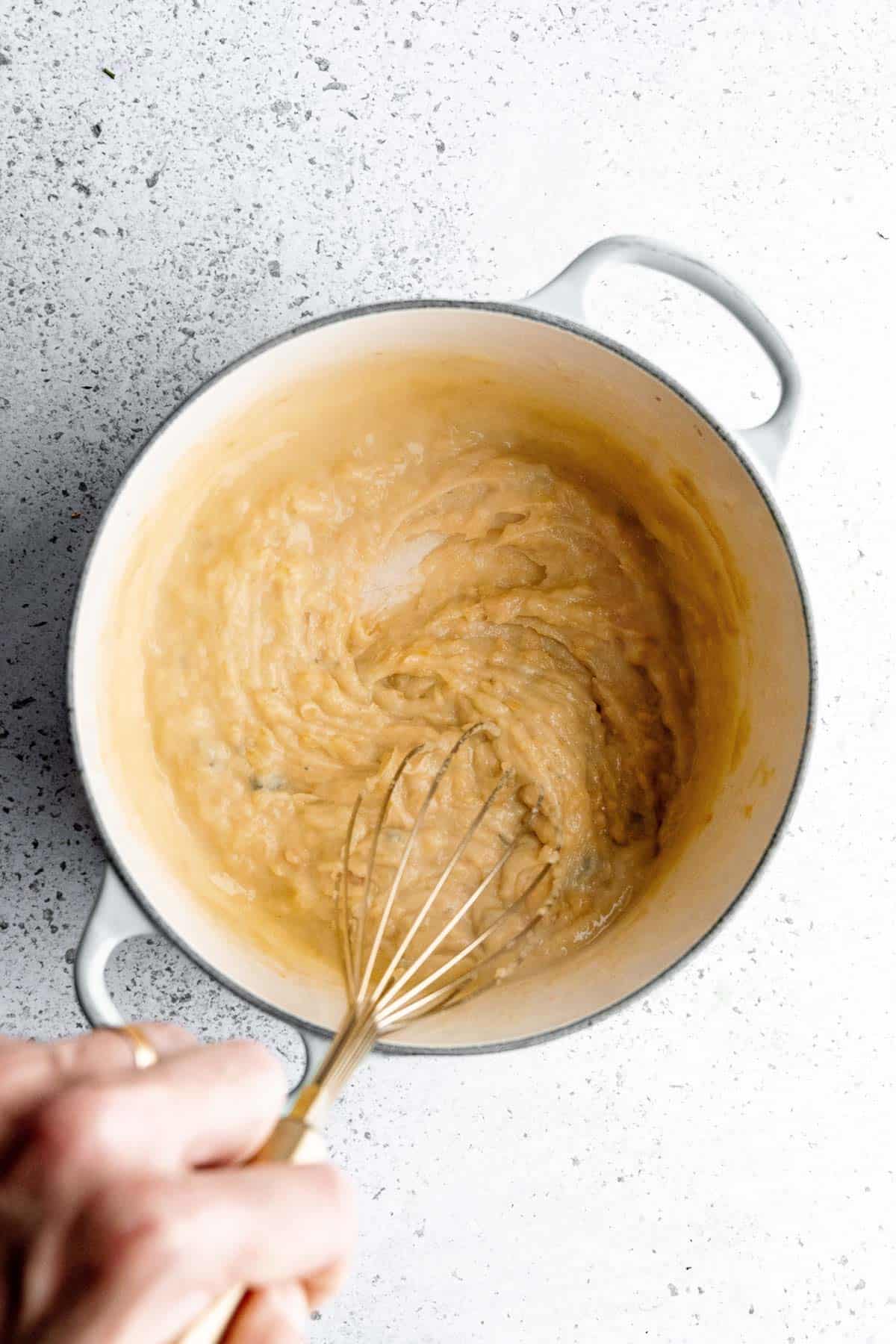 Hand whisking the roux.