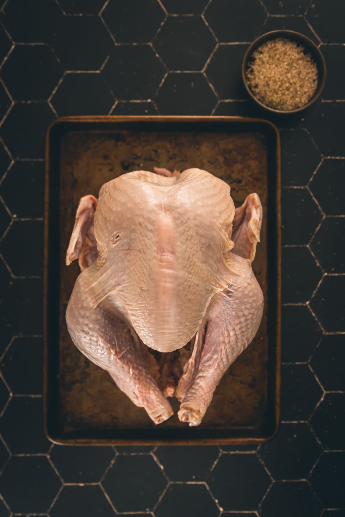 Turkey and brine ingredients on a black board.