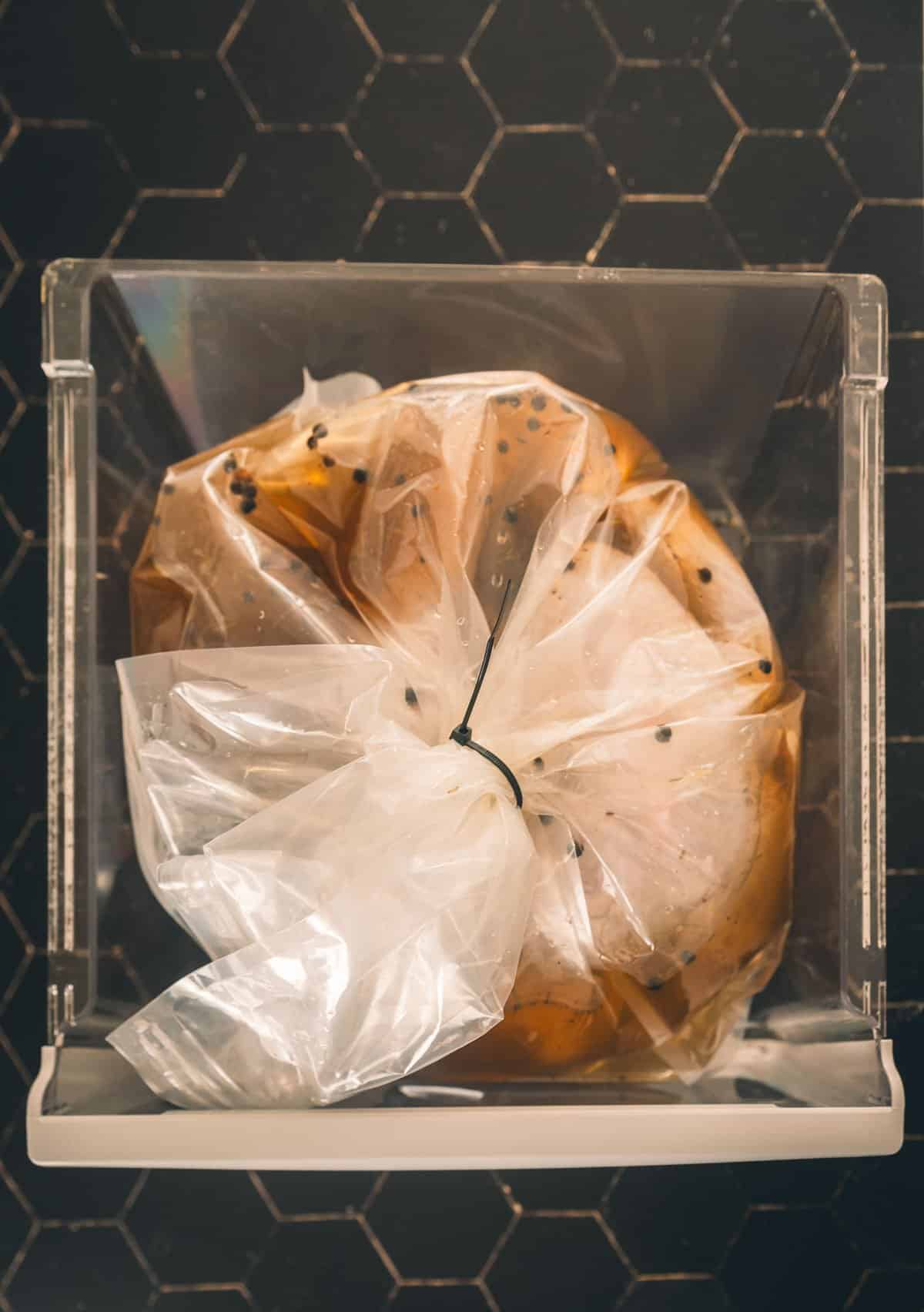 Turkey in brine bag in fridge drawer.