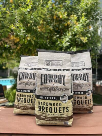 Cowboy wood pellets on a table next to a pool, perfect for smoking turkey.