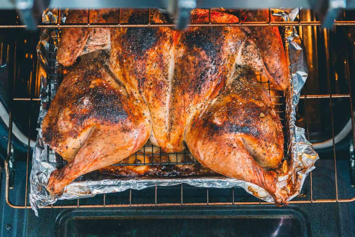 Overhead shot of spatchcock turkey coming out of the oven. 