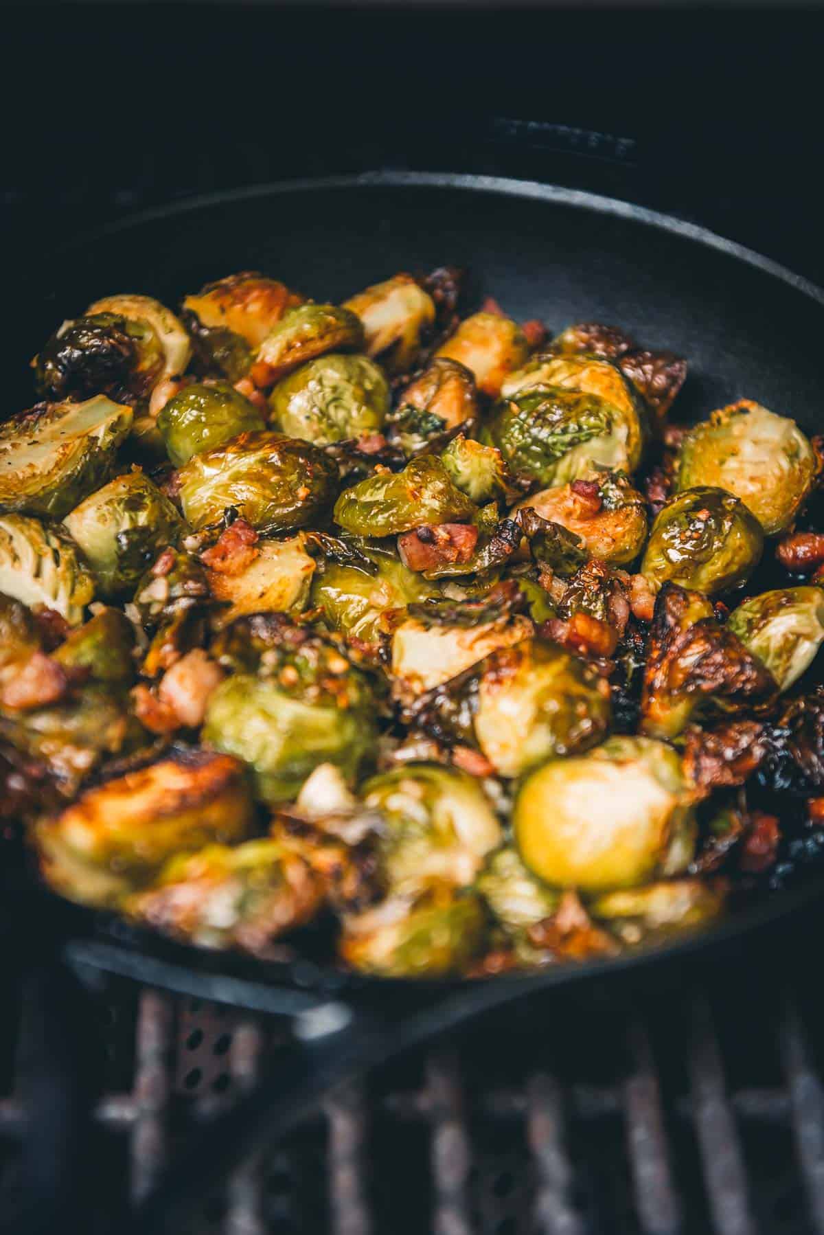 Brussels sprouts in a skillet on the grill.