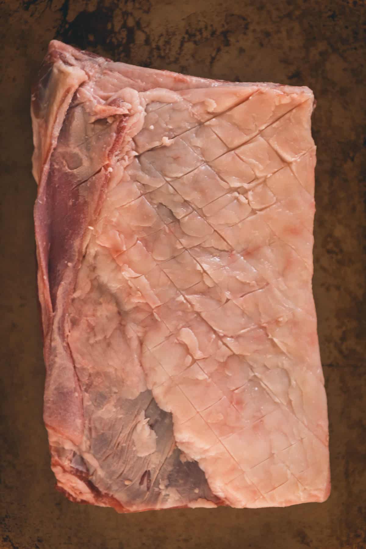 Close up of the fat to show the shallow knife cuts to score the meat.