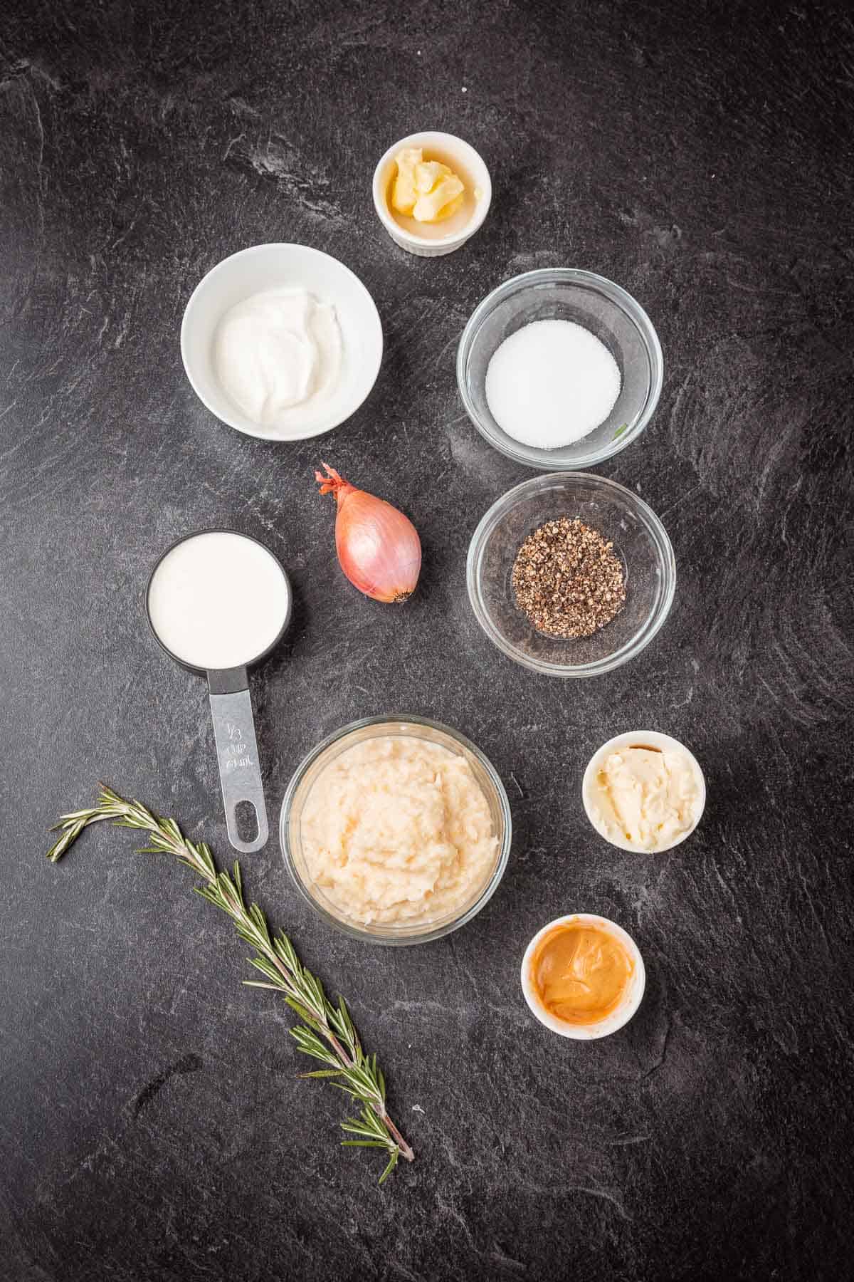 The ingredients for a horseradish cream sauce on a black background.