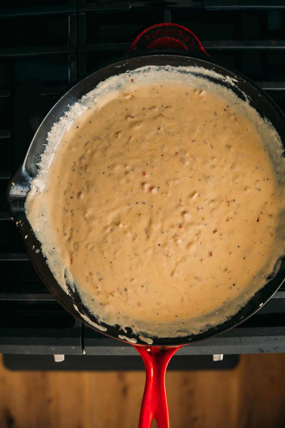 A cast iron skillet pan with a sauce.