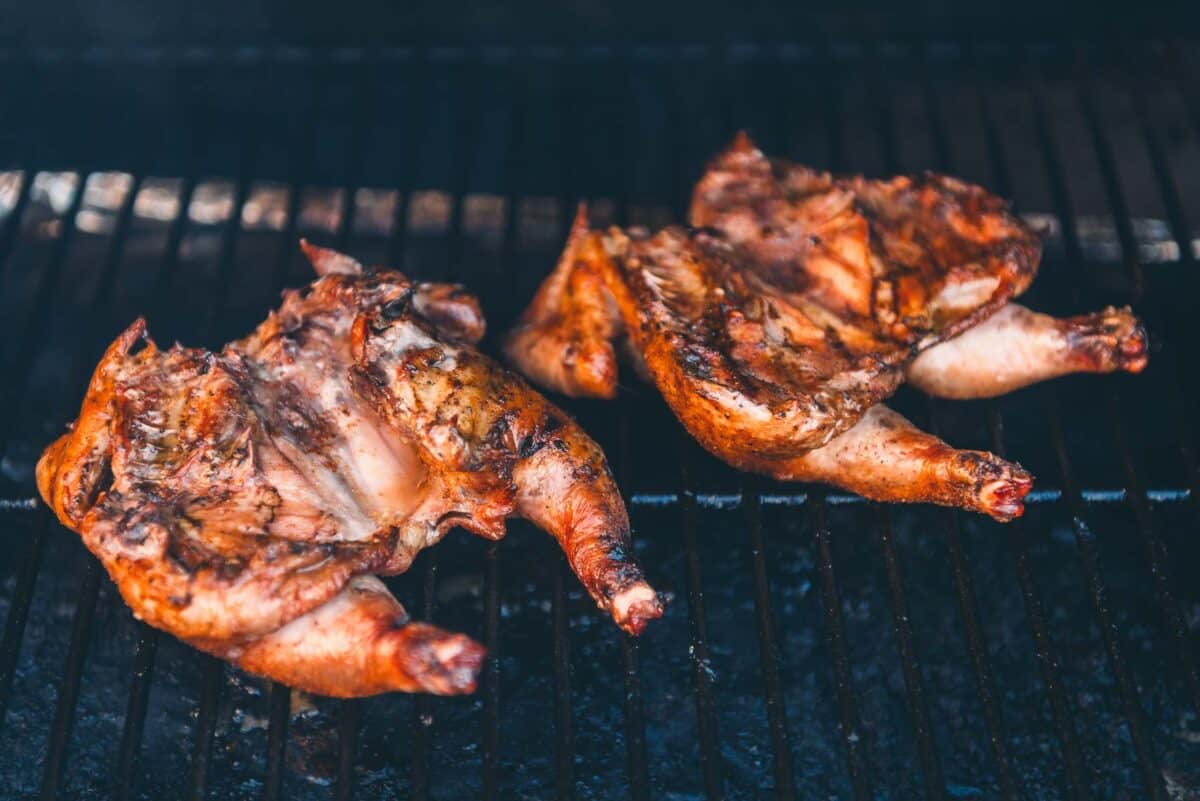 Two Cornish hens are being cooked on a grill.