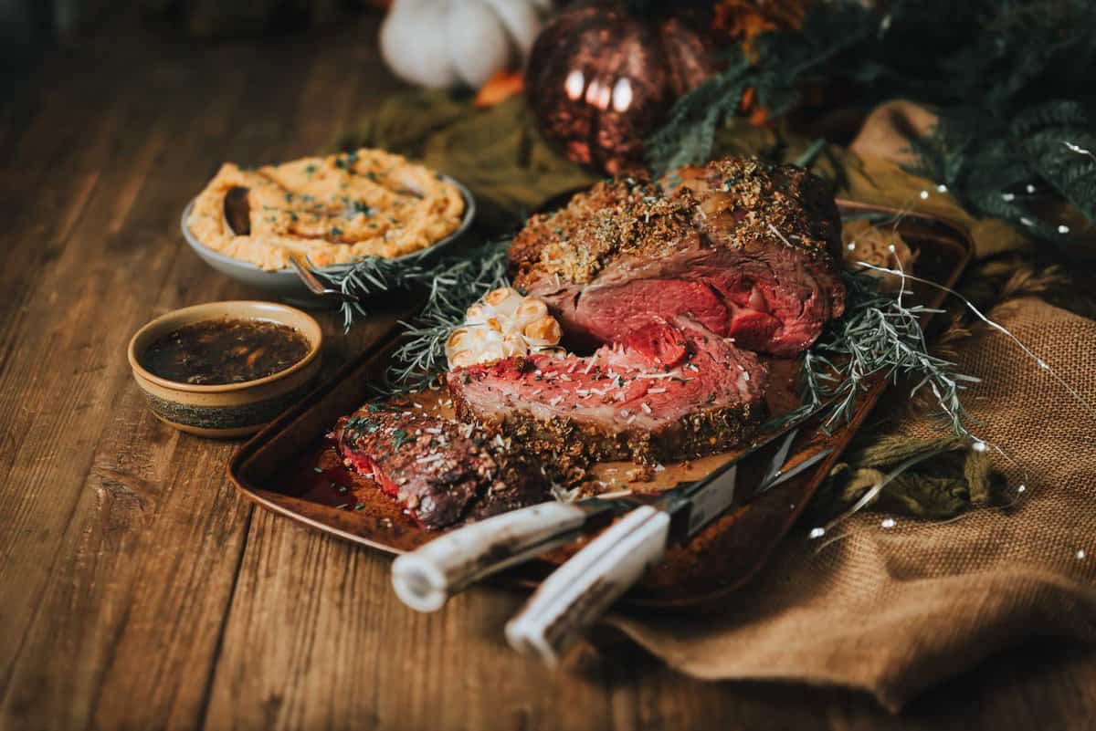 Prime rib roast on a wooden table.