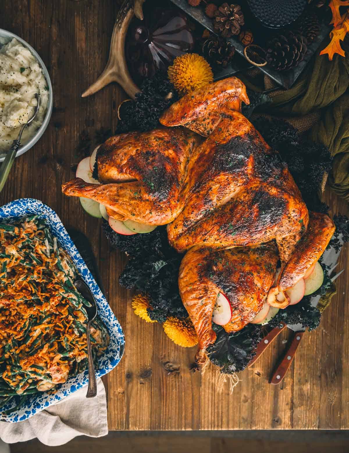 Roast spatchcock turkey on a table for serving with side dishes. 