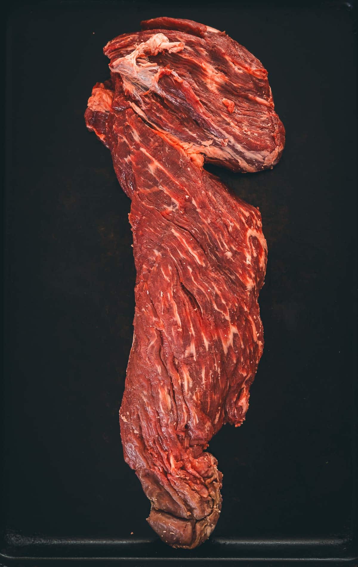 Whole beef tenderloin, that hasn't been tied to show the long head and tail end of the roast.