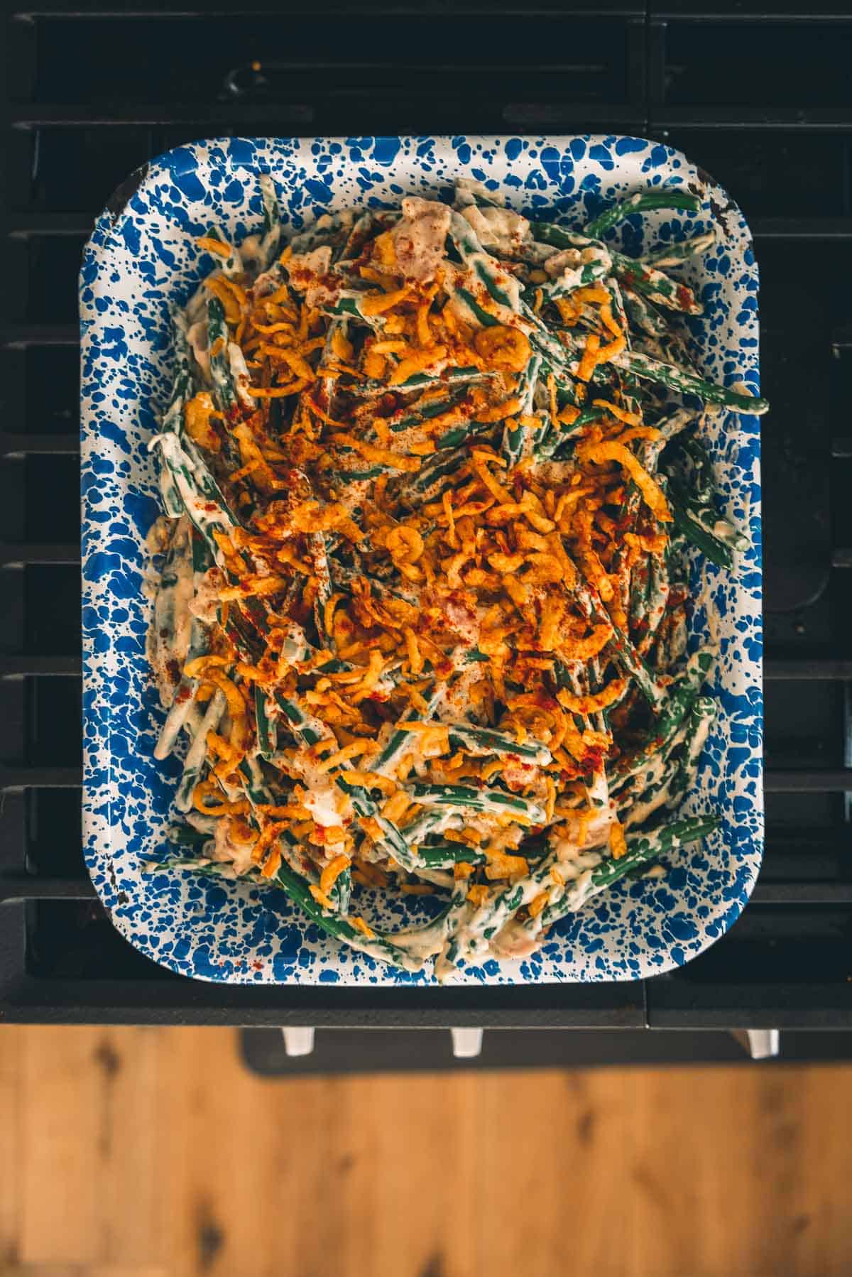 A plate of green beans on a stove top.