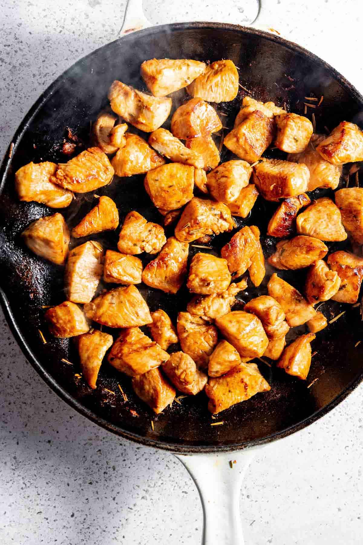 Fried chicken in a frying pan.