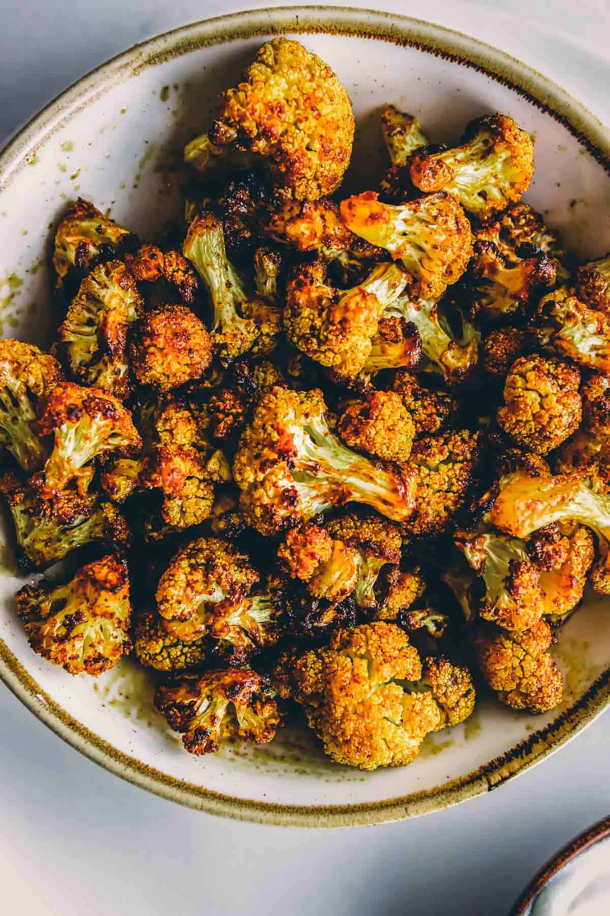 Roasted cauliflower in a bowl on a table.