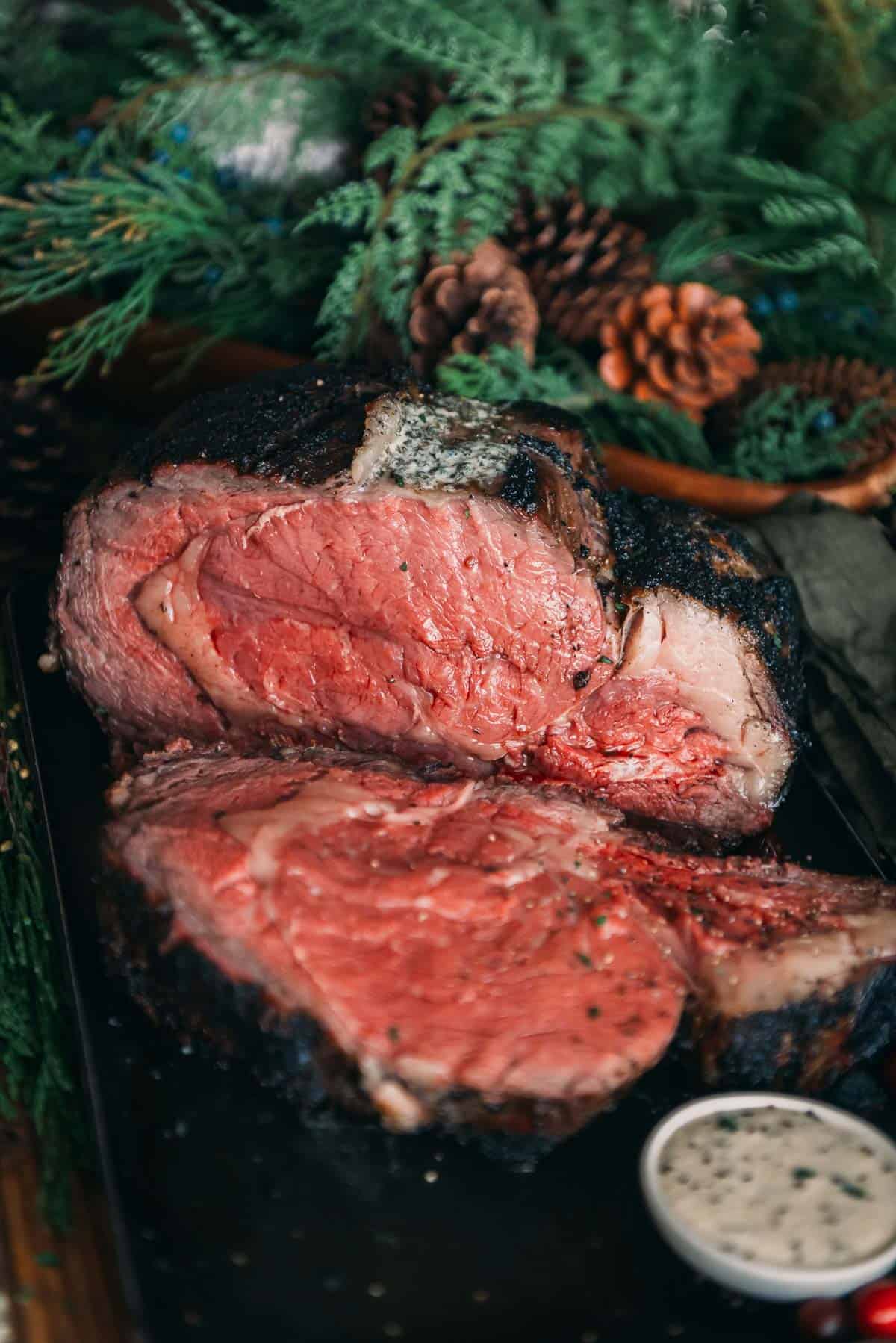 A piece of prime rib sitting on a black tray.