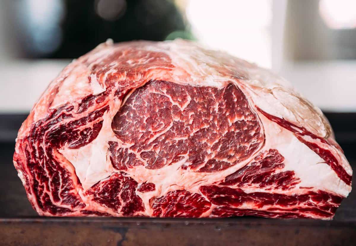 A large piece of beef is sitting on top of a pan.