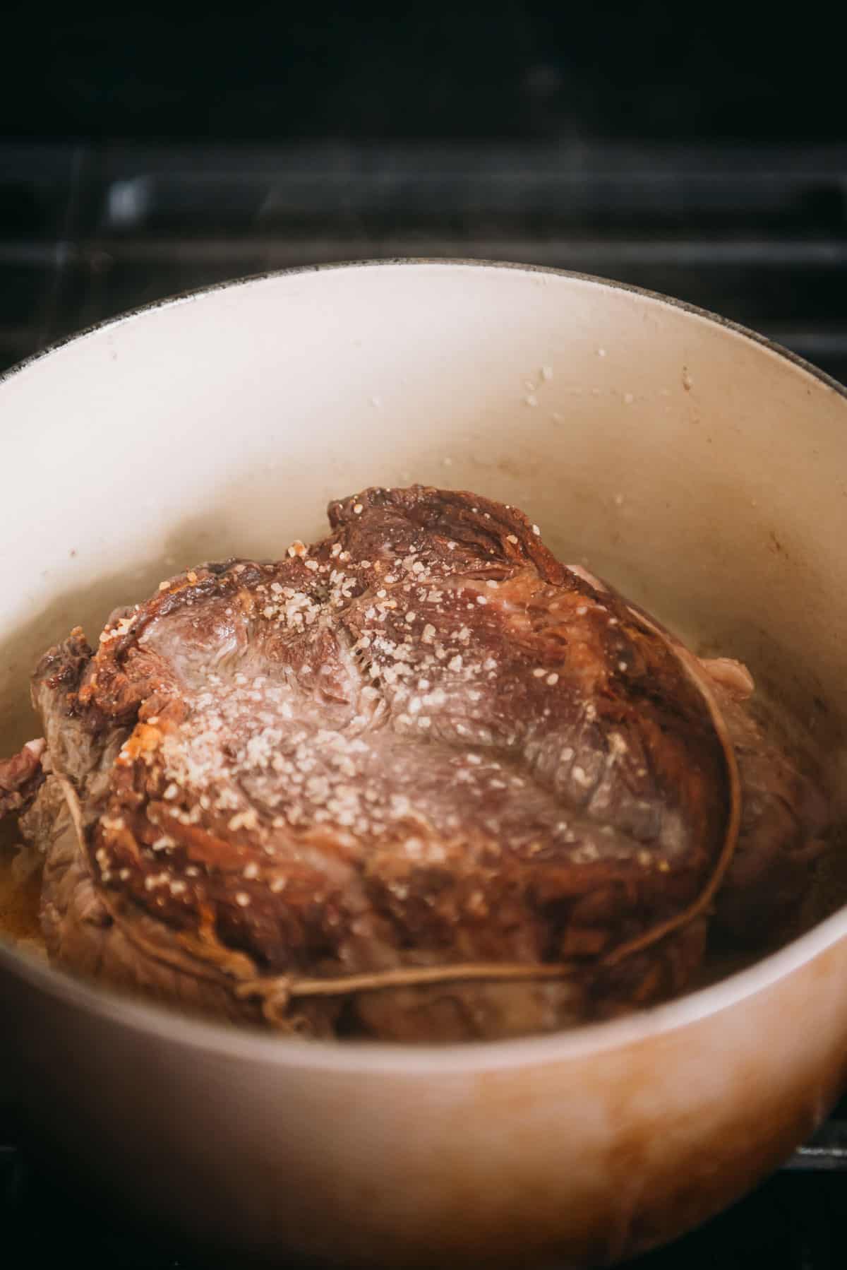 Browned chuck roast in a Dutch oven.