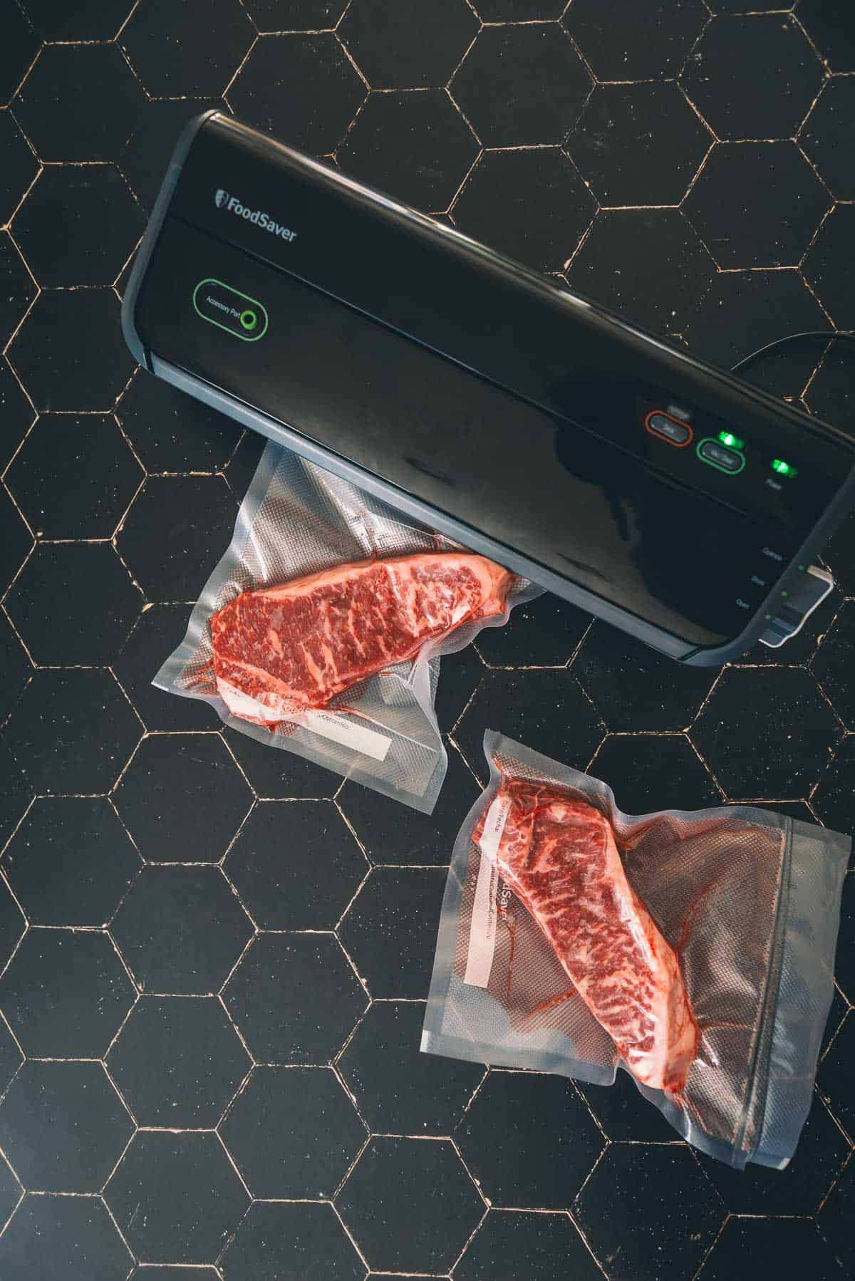 A vacuum sealer sealing strip steaks.