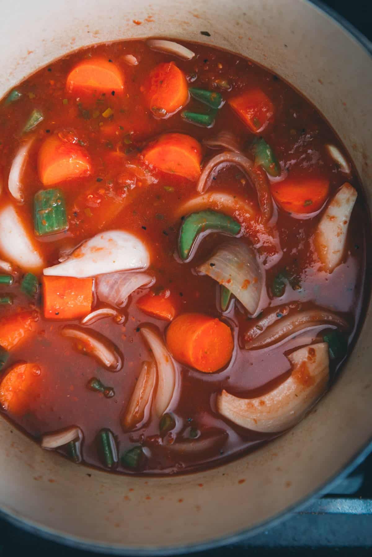 Liquid added to the vegetables in a Dutch oven.