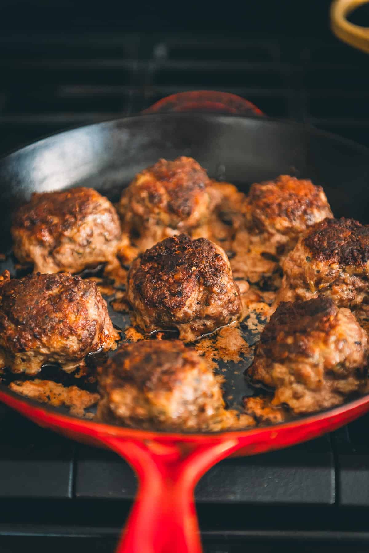 Meatballs in a skillet on the stove.