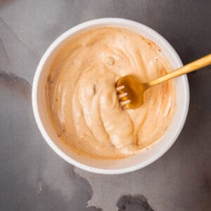 A bowl of chipotle aioli with a fork in it.
