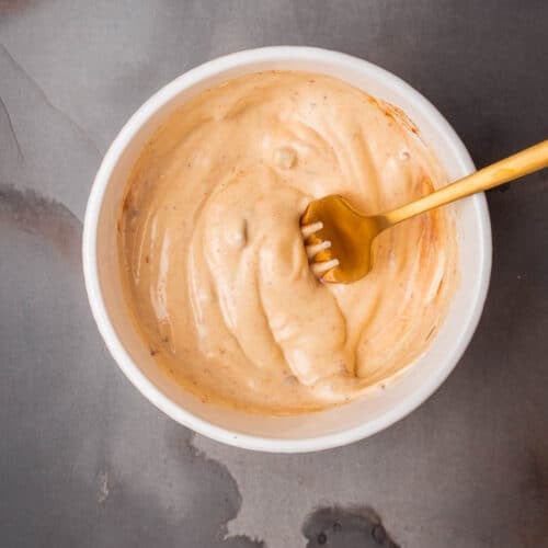 A bowl of chipotle aioli with a fork in it.