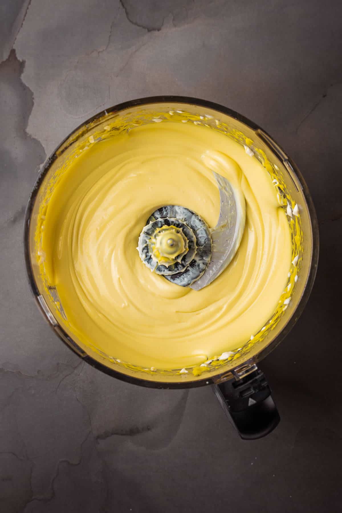 A yellow batter in a mixing bowl.