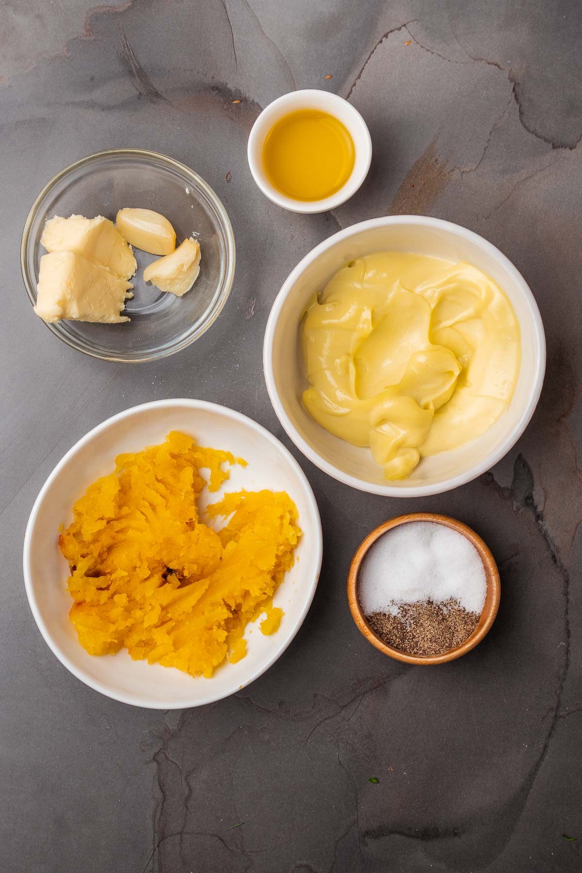 Three bowls of ingredients for a roasted squash aioli recipe.