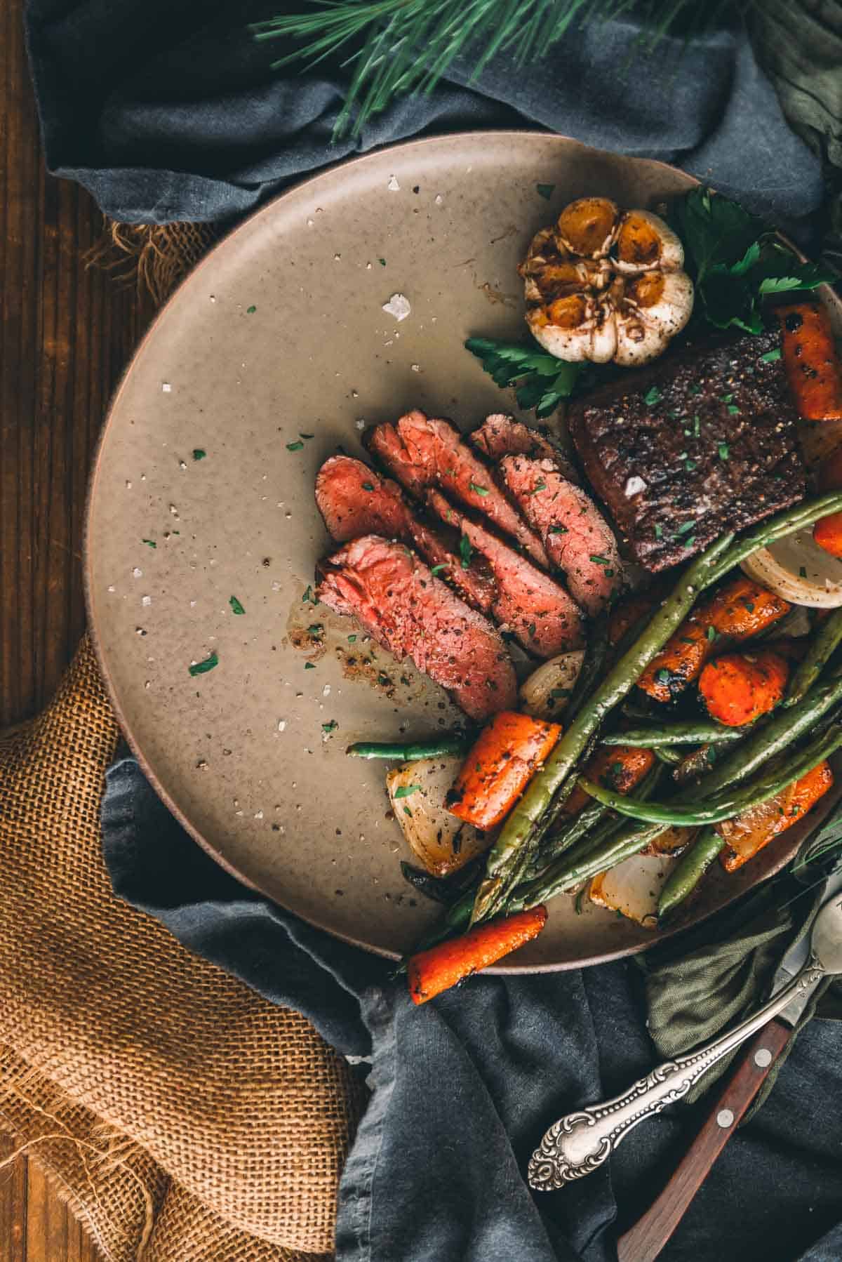 Steak and vegetables on a plate.