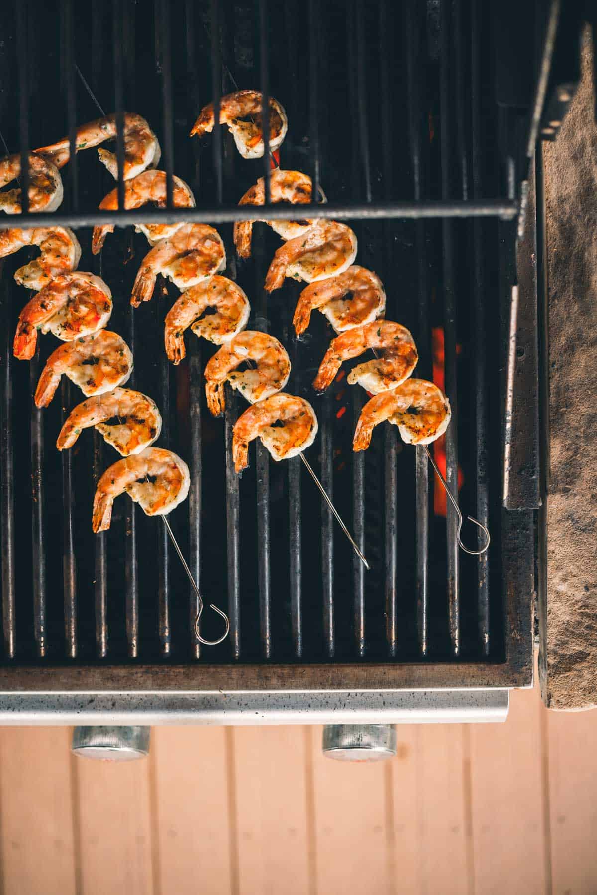 Skewered shrimp grilling on a barbecue grill.