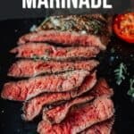 Sliced London broil steak served on a dark surface, garnished with herbs. Text overlay reads, "The Best London Broil Marinade," pinterest image.