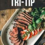 Pinterest image for smoked tri-tip with a platter of sliced meat and garnish.