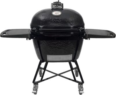 A black ceramic kamado grill with a domed lid, temperature gauge, foldable side tables, and a wheeled metal stand offers everything you need to learn how to use a kamado grill effectively.