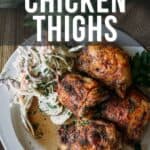 Image of grilled chicken thighs and coleslaw on a plate. Text reads, "How to make grilled chicken thighs. Get the full recipe on girlcarnivore.com.