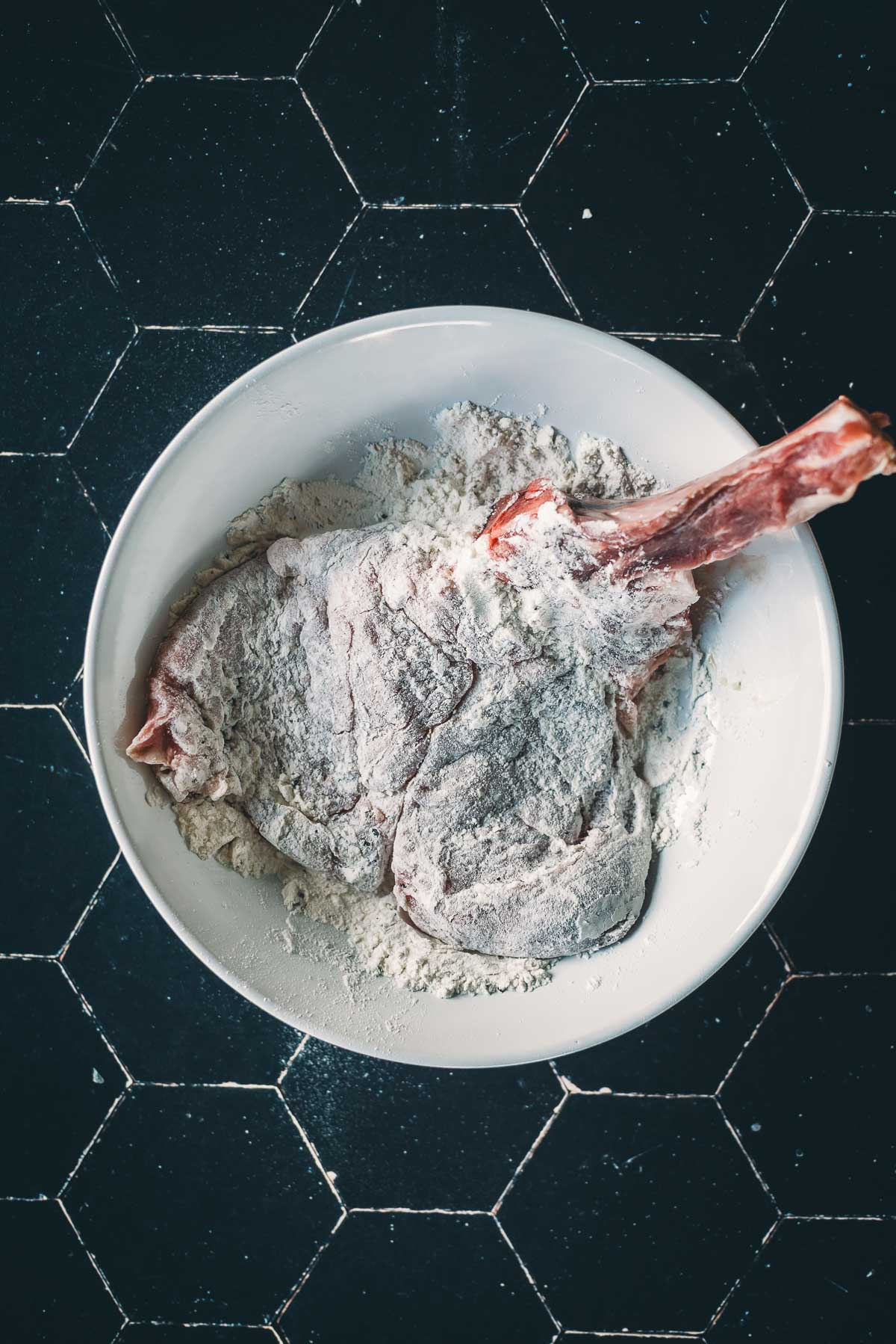 Veal dredged in a bowl of flour.