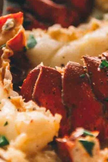 Close-up of a dish featuring lobster meat garnished with chopped herbs, served in a bowl.